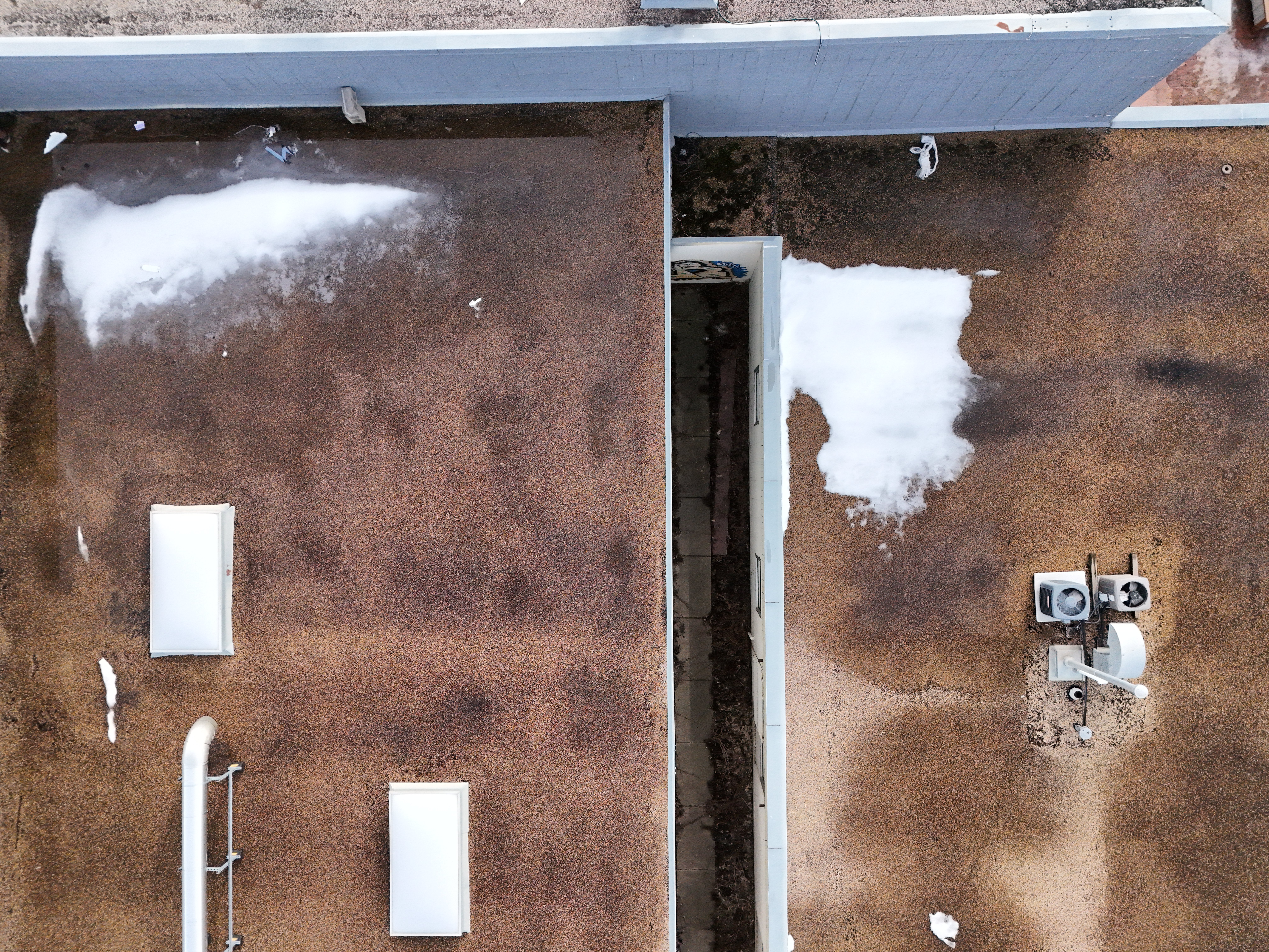 Aerial view of a commercial building roof in Edmonton as during thaw season Alberta winter